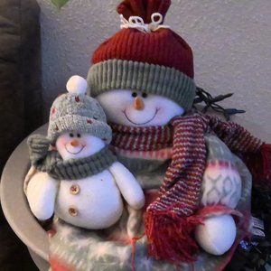 Snowman holding baby